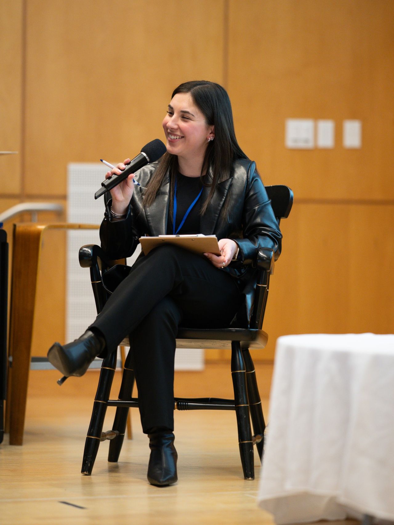 Speaker seated onstage at a MACSMAC event