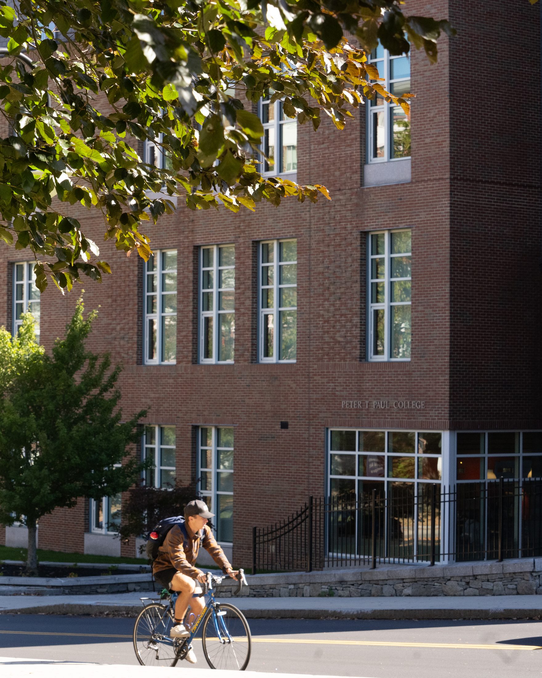 Cyclist passing a campus building